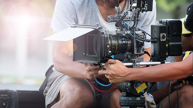 image of a videographer man holding camera