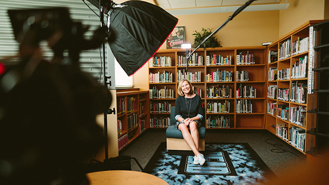 Woman in front of book case 