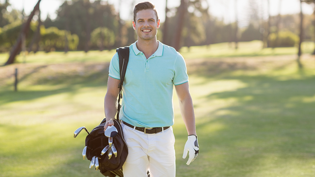 Man in blue shirt on golf course 